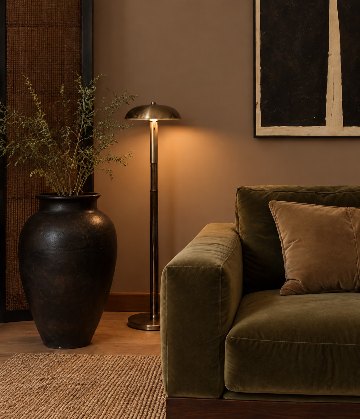 Carme — olive velvet sofa beside a brass floor lamp